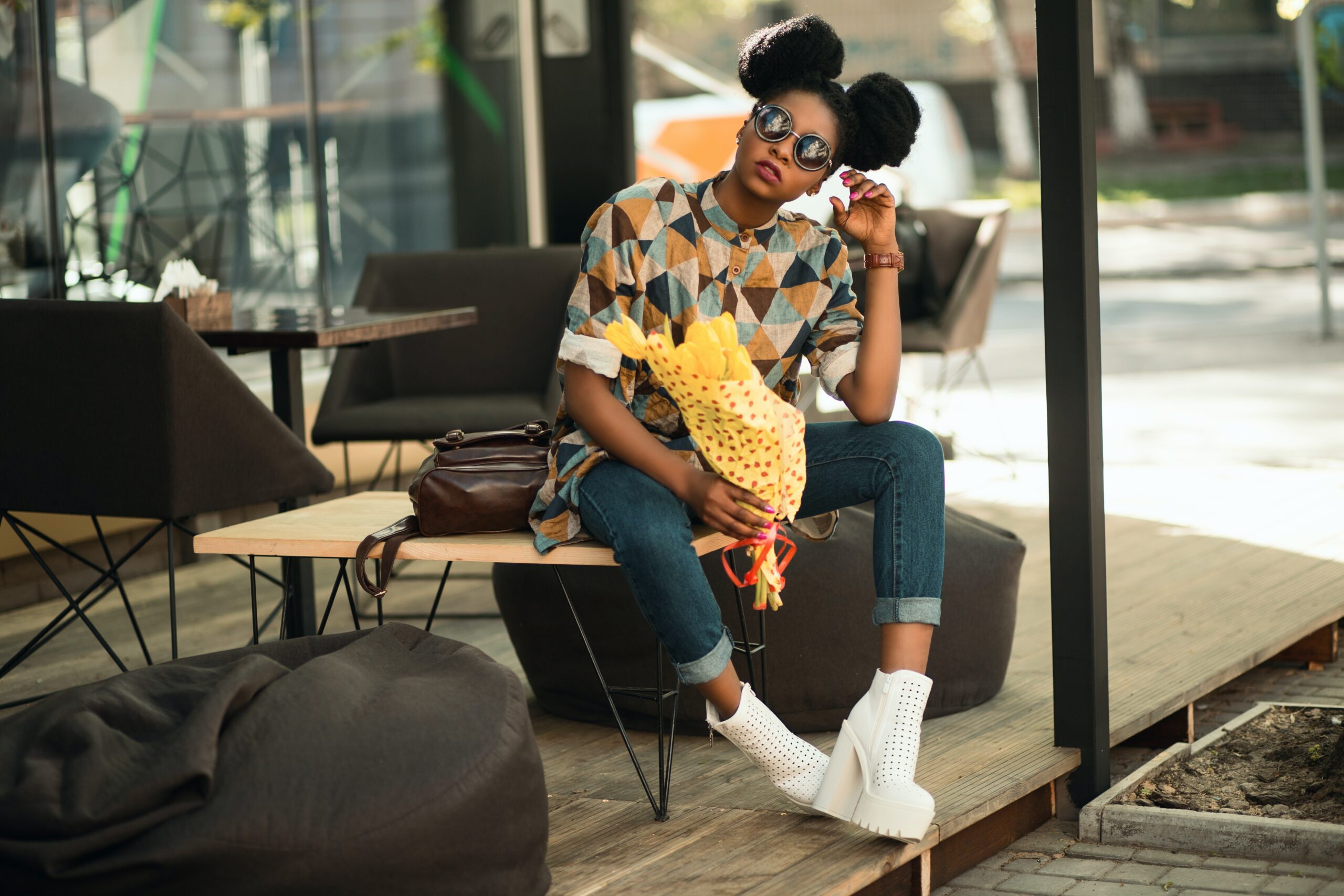 woman-in-brown-and-gray-t-shirt-sitting-on-brown-wooden-table