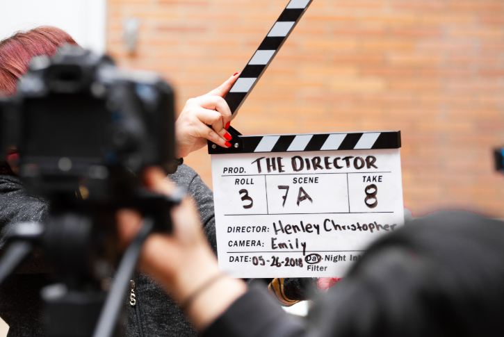 A man with a clapperboard